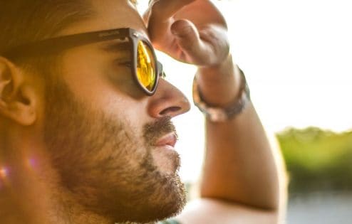 Man with sunglasses looking forward