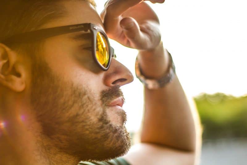 Man with sunglasses looking forward