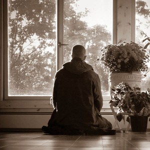 Silhouette of a monastic meditating.