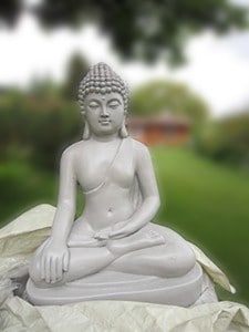 A white Buddha statue on the lawn at the Abbey.