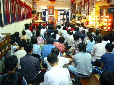 Students seated, listening to Venerable give a Dharma talk.
