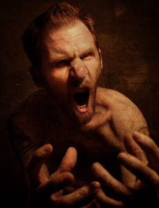 A man showing his very angry face and open mouth.