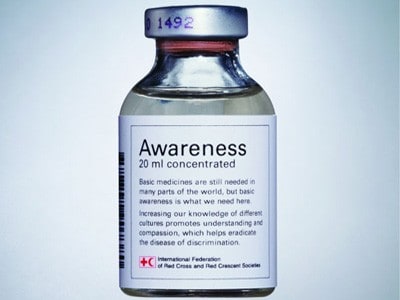 A glass medicine bottle with the label Awareness, 20ml concentration, Basic medicines are still needed in many parts of the world, but basic awareness are what we need here. Increasing knowledge of different cultures promotes understanding and compassion, which helps eradicate the disease of discrimination.