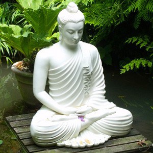 Statue near a pond of a Buddha meditating.