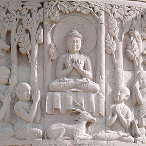 Decorative carving of the Buddha teaching at Deer Park.