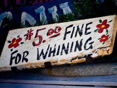 Hand-painted sign that says '$5.00 for whining'.