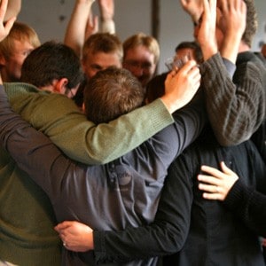 A group of people, hugging.
