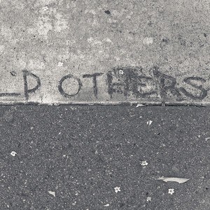 The words 'Help others' written on a concrete sidewalk.