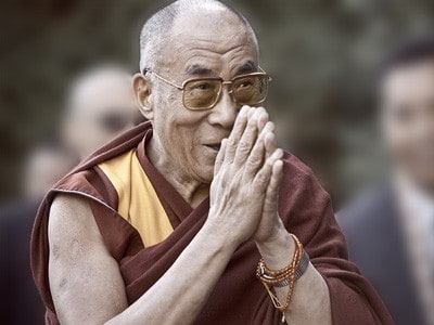 His Holiness with palms together.