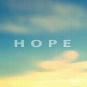 The word 'HOPE' superimposed in front of a sunrise.