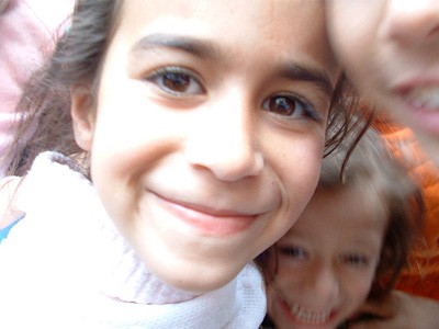 Closeup of a smiling Iraqi girl.