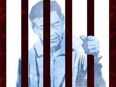 Image of a man behind bars, one of his hands holding the bar.