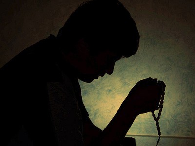 Silhouette of Muslim in prayer.