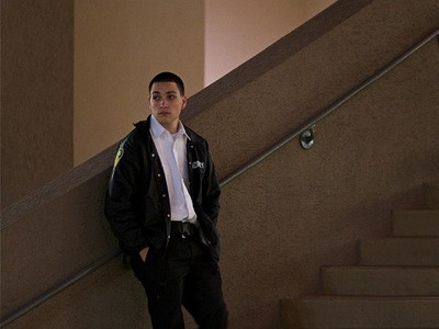 Prison worker standing on a staircase.