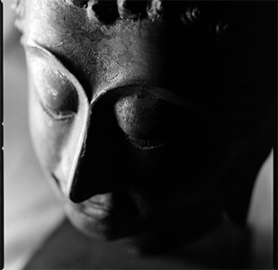 Black and white image of a buddha's face.