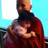 Venerable Chodron holding a baby.