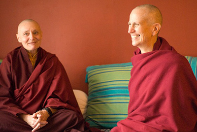 Venerable Chodron, smiling, with Jetsunma Tenzin Palmo.