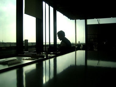 A man working in office facing the window