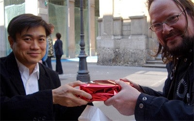 Man giving a gift to another man.