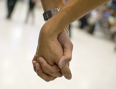 Couple holding hands.