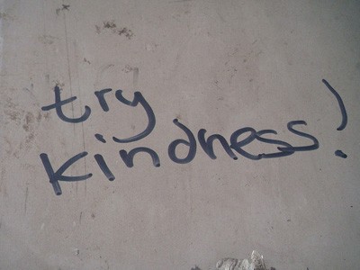 "Try kindness!" handwritten on a wall.