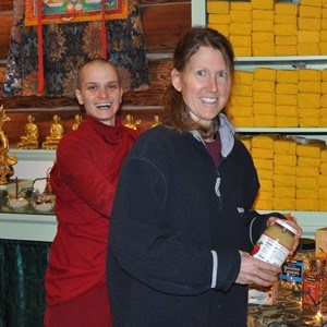 Venerable Jampa and Heather arranging the altar.