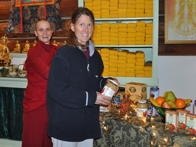 Venerable Jampa and Heather, arranging the altar.