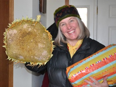 Julia holding a big sunflower she brought to offer the Abbey.