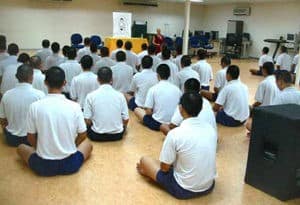 Prisoners at a Singapore prison listen as Venerable Chodron gives a Dharma talk.