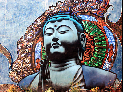 Graffiti image of a Buddha's face.