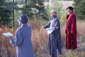 Venerable outside with two other nuns, discussing the Abbey boundary.