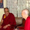 Venerable sitting with His Holiness the Dalai Lama.