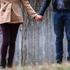 A woman and a man holding hands together.