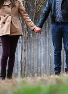 A woman and a man holding hands together.