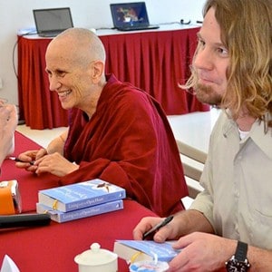 Venerable Chodron and Russell Kolts signing books.