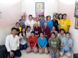 Venerables Chodron and Samten sitting with inmates in Medan women's prison.