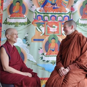 Venerable Chodron and Ayya Tathaaloka sitting together and smiling.