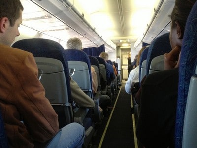 Passengers seated in an airplane cabin.