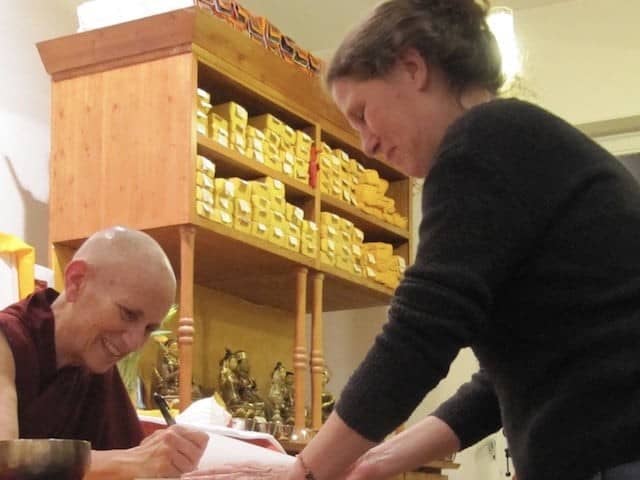 Czcigodny Chodron podpisuje książkę dla studenta Dharmy w Tibet House we Frankfurcie.