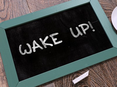 Chalkboard with the words "Wake up!" written on it.