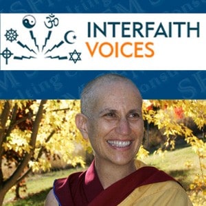 Venerable smiling with Interfaith Voices logo in background.