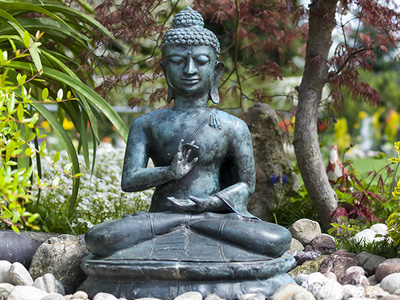 Buddha statue in a garden.