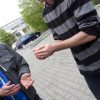 Two young men passing a hot potato.