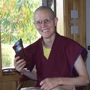 Venerable Tarpa holding a gift and smiling.