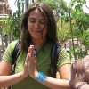 Young woman with palms together.