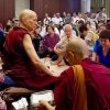 Venerable Chodron teaching in front of a large group of people.