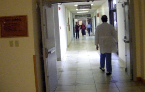 Doctor walking down hospital corridor.