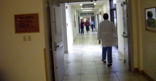 Doctor walking down hospital corridor.