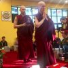 Venerable Chodron demonstrating walking while chanting Namo Amitabha.