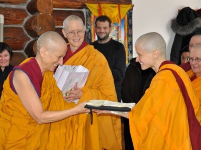 Ven. Jampa giving a gift to Ven. Chodron.